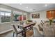Bright dining area with a long wooden table and view to the backyard at 617 Apricot Rose Pl, Las Vegas, NV 89138