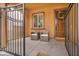 Inviting front porch with seating, a decorative door and a gated entry at 617 Apricot Rose Pl, Las Vegas, NV 89138