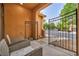 Inviting front porch with comfortable seating and a gated entrance at 617 Apricot Rose Pl, Las Vegas, NV 89138