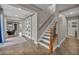 Hallway featuring a staircase, slider barn doors, and access to living spaces, tile floors at 617 Apricot Rose Pl, Las Vegas, NV 89138