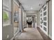 Hallway with slider doors to the patio, view into the living room, tile floors and neutral walls at 617 Apricot Rose Pl, Las Vegas, NV 89138