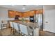 Large kitchen island with granite countertops and seating complements the stainless steel appliances and ample cabinet space at 617 Apricot Rose Pl, Las Vegas, NV 89138