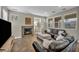 Cozy living room with a fireplace, tile floors, and large windows that bring in lots of natural light at 617 Apricot Rose Pl, Las Vegas, NV 89138