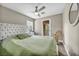 Comfortable main bedroom with neutral decor, a ceiling fan, a large window and balcony access at 617 Apricot Rose Pl, Las Vegas, NV 89138