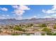 Scenic view of the neighborhood homes with solar panels, surrounded by mountains and clear skies at 617 Apricot Rose Pl, Las Vegas, NV 89138