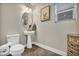 Neutral powder room with decorative mirror and fixtures, complemented by modern toilet at 617 Apricot Rose Pl, Las Vegas, NV 89138