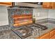 This modern kitchen features granite countertops, a tile backsplash, and a high-end stainless steel gas cooktop at 617 Apricot Rose Pl, Las Vegas, NV 89138