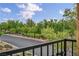 Balcony view with black wrought iron railing overlooks tree-lined street in a desirable location at 617 Apricot Rose Pl, Las Vegas, NV 89138