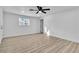 Spacious bedroom featuring new flooring, fresh paint, ceiling fan, and ample natural light from a large window at 617 Stanford St, Las Vegas, NV 89107