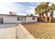 Inviting single-story home with a well-maintained yard, fresh white paint and mature palm trees enhancing curb appeal at 617 Stanford St, Las Vegas, NV 89107