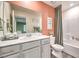 Stylish bathroom with white vanity, framed mirror, neutral walls, and a shower-tub combo with coordinating accents at 6525 Cinnamon Hazelnut St # Lot 92, North Las Vegas, NV 89084