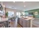 Open concept kitchen with island, stainless steel appliances, and dining area leading to the backyard at 6525 Cinnamon Hazelnut St # Lot 92, North Las Vegas, NV 89084