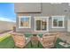 Inviting outdoor seating area with wicker chairs on the grass, featuring a view of the home's exterior at 6525 Cinnamon Hazelnut St # Lot 92, North Las Vegas, NV 89084