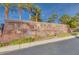 Stone community sign with 'Marseilles' lettering, landscaping, and palm trees at 69 Bellissima Lago Ct, Henderson, NV 89011