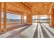 Spacious living room features wood framing, large windows, and lake view at 69 Bellissima Lago Ct, Henderson, NV 89011