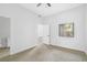 Bedroom with neutral carpet, ceiling fan, and bathroom entrance at 700 Carnegie St # 3913, Henderson, NV 89052