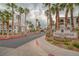 Condominium complex entrance with signage and palm tree lined street at 700 Carnegie St # 3913, Henderson, NV 89052