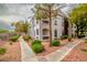 Condo building exterior with well-maintained landscaping, featuring sidewalks and leafy trees at 700 Carnegie St # 3913, Henderson, NV 89052
