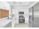 Bright kitchen features white cabinetry, marble countertops, and stainless steel appliances at 700 Carnegie St # 3913, Henderson, NV 89052