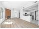 Bright and airy living room leading to kitchen, with wood-look floors and a modern fireplace at 700 Carnegie St # 3913, Henderson, NV 89052