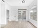 Bright living room with wood-look flooring, sliding glass doors, and arched window at 700 Carnegie St # 3913, Henderson, NV 89052