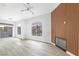 Open living room with wood-look floors, modern fireplace, and sliding glass doors leading to the outside at 700 Carnegie St # 3913, Henderson, NV 89052