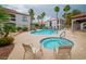 Inviting community pool and spa surrounded by lounge chairs and swaying palm trees at 700 Carnegie St # 3913, Henderson, NV 89052