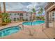 Community pool and jacuzzi with lounging chairs, landscaping, and nearby condos at 700 Carnegie St # 3913, Henderson, NV 89052