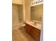 A well-lit bathroom with a vanity, toilet, and shower with new tile at 7131 S Durango Dr # 104, Las Vegas, NV 89113