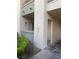 Condominium exterior with neutral colors and a small garden in front of the building at 7131 S Durango Dr # 104, Las Vegas, NV 89113