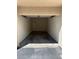 A clean and empty garage with a concrete floor and automatic door opener at 7131 S Durango Dr # 104, Las Vegas, NV 89113