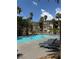 A large community pool with lounge chairs and a patio at 7131 S Durango Dr # 104, Las Vegas, NV 89113
