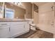 Well-lit bathroom features granite countertops, white cabinets, and a shower-tub combination at 7189 S Durango Dr # 203, Las Vegas, NV 89113
