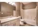 Well-lit bathroom features a granite countertop, updated fixtures and a tub with shower at 7189 S Durango Dr # 203, Las Vegas, NV 89113