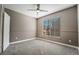 Cozy bedroom with neutral paint, carpet, ceiling fan, and large window with blinds at 7189 S Durango Dr # 203, Las Vegas, NV 89113