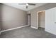 This bedroom features neutral walls, carpet floors, a ceiling fan and a closet at 7189 S Durango Dr # 203, Las Vegas, NV 89113