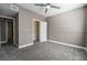 Neutral bedroom with gray carpet, ceiling fan, trim, and walk-in closet at 7189 S Durango Dr # 203, Las Vegas, NV 89113