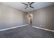 Comfortable bedroom with neutral carpet, overhead fan, and a closet for easy storage at 7189 S Durango Dr # 203, Las Vegas, NV 89113