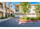 Condominium building showing attached garages, landscaping, and mature palm trees at 7189 S Durango Dr # 203, Las Vegas, NV 89113