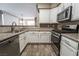 Well-equipped kitchen featuring a stainless steel dishwasher, oven, and granite countertops at 7189 S Durango Dr # 203, Las Vegas, NV 89113