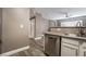 Cozy kitchen area featuring a stainless steel dishwasher, and countertops with eat in bar at 7189 S Durango Dr # 203, Las Vegas, NV 89113