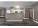 Open kitchen view with white cabinets, granite countertops, and stainless steel appliances at 7189 S Durango Dr # 203, Las Vegas, NV 89113
