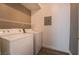 Convenient laundry room with washer, dryer, wire shelving for storage at 7189 S Durango Dr # 203, Las Vegas, NV 89113