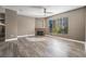 Open living room with a decorative fireplace, large window, and wood-look floors at 7189 S Durango Dr # 203, Las Vegas, NV 89113