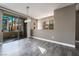 Bright living room featuring sliding glass doors to balcony, modern floors and neutral paint at 7189 S Durango Dr # 203, Las Vegas, NV 89113