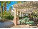 Outdoor picnic area featuring green tables, a grill and shade from the sun at 7189 S Durango Dr # 203, Las Vegas, NV 89113