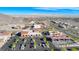 An aerial view of the commercial property shows a parking lot and multiple businesses at 729 Scottsdale St, Henderson, NV 89002