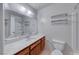 Bathroom featuring a stand up shower, white toilet, white countertop and a large mirror at 729 Scottsdale St, Henderson, NV 89002