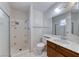 Bathroom featuring a stand up shower, white tile, white toilet and sink with white countertop at 729 Scottsdale St, Henderson, NV 89002