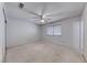 A bright bedroom with neutral carpet, ceiling fan, a window with blinds and a closet at 729 Scottsdale St, Henderson, NV 89002